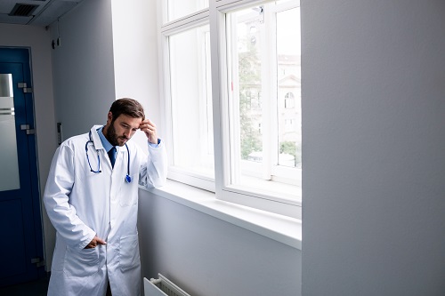Doctor standing near a window