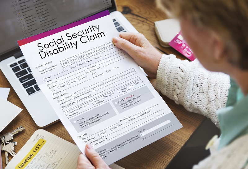 woman looking ta social security disability claim form