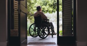 A man sits in a wheelchair and wonders how to win disability benefits for MS.