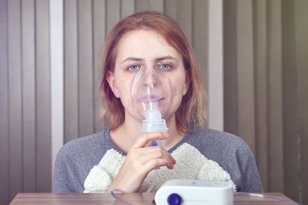woman using breathing device