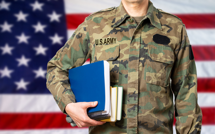 student veteran with book preparing to apply for a scholarship