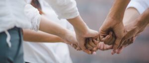 A panoramic team business combines concept, a business team standing together, and volunteer charity work.