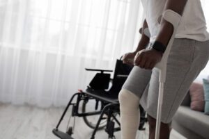 Chronic Illness and Long-Term Disability: What Insurers Get Wrong man with broken leg and crutches, wheelchair