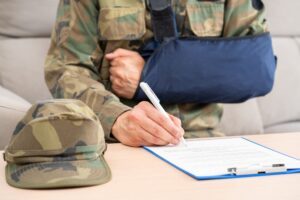 Military veteran filling out a VA disability claim using Form 21-526EZ