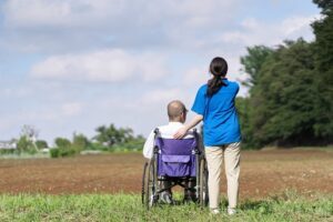 Caregiver standing behind a person in a wheelchair looking out over a field If you'd like, I can search for images more specifically tied to the mental-health-and-disability-claim angle (e.g., someone reviewing a denial letter, a therapy/counseling setting, or a termination notice) instead — just let me know.