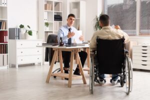 Lawyer meets with client to explain how to win a disability claim for degenerative disc disease.
